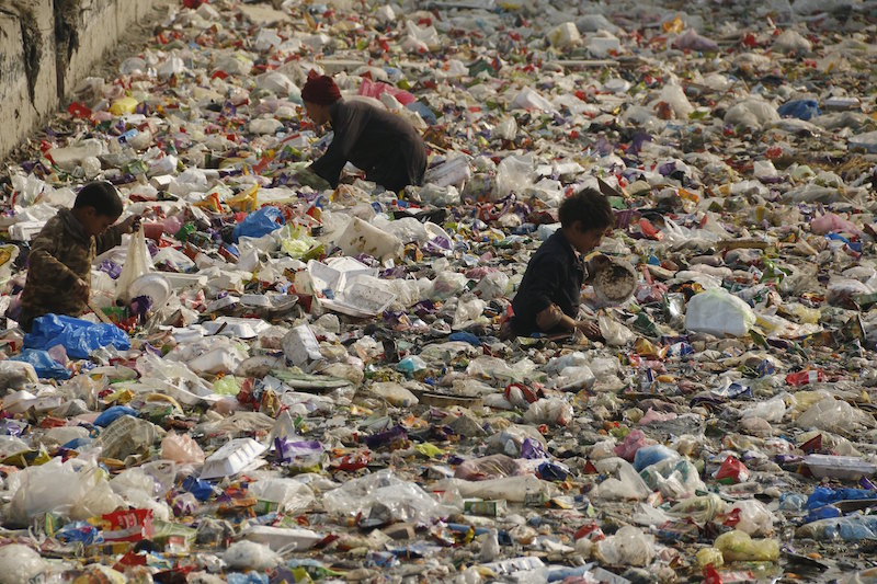Children look for recyclable plastic in a canal in Peshawar January 17, 2016. u00e2u20acu201d Reuters pic