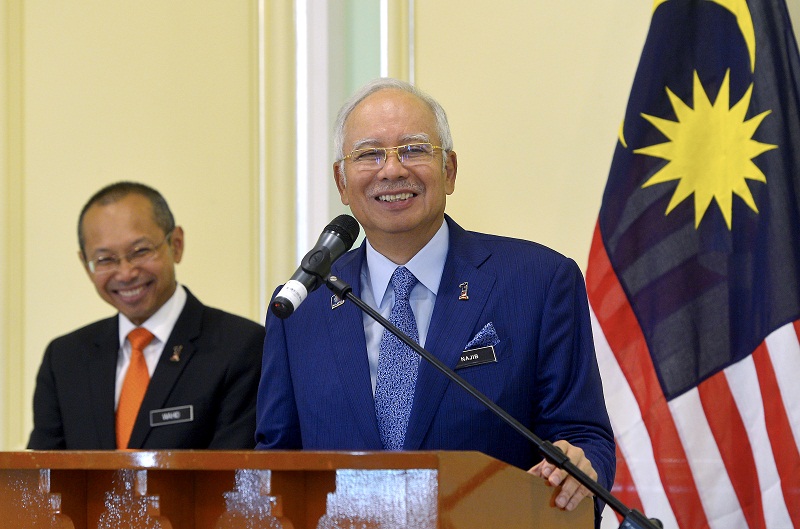 Prime Minister Datuk Seri Najib Razak (right) reacts during a press conference on the proposed recalibration of Budget 2016 in Putrajaya January 15, 2015. u00e2u20acu201d Bernama pic