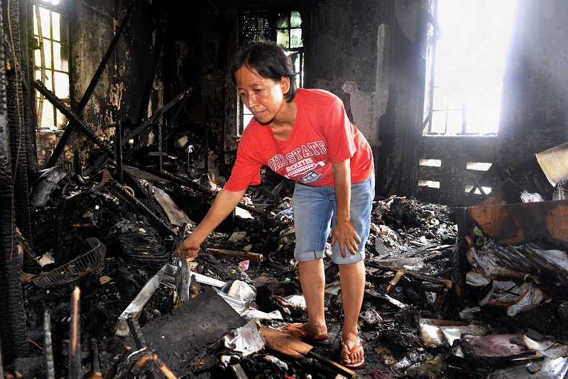 A worker of the budget hotel picks through the rubble after the fire last week. There were three guests in the hotel during the incident but they escaped. u00e2u20acu201d Picture by R. Mahgeshan
