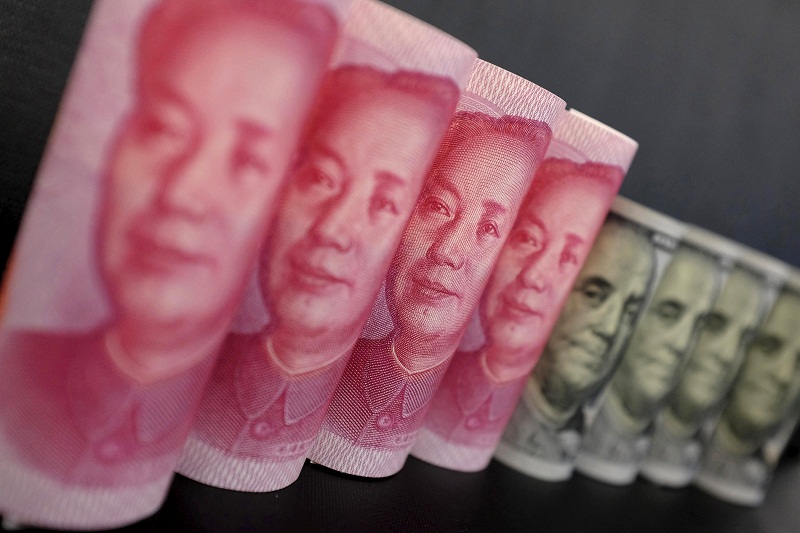 US$100 banknotes and Chinese 100 yuan banknotes are seen in this file picture illustration in Beijing, China, January 21, 2016. u00e2u20acu201d Reuters pic