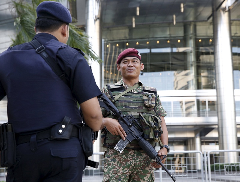 A soldier and a police officer patrol outside a shopping mall in Kuala Lumpur on January 25, 2016. u00e2u20acu201d Reuters pic