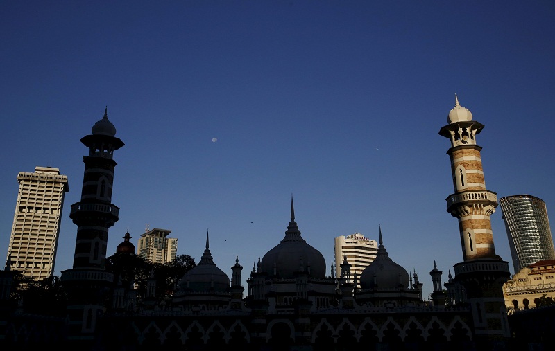 A mosque is silhouetted against city buildings in Kuala Lumpur on January 27, 2016. u00e2u20acu201d Reuters pic