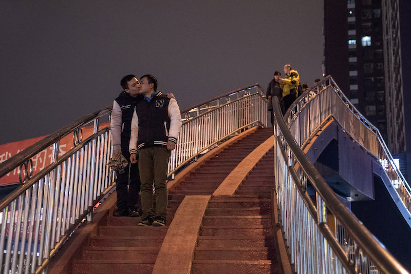 Sun Wenbin (leftt) kisses his boyfriend Hu Mingliang on a bridge in Changsha January 27, 2016. u00e2u20acu201d Picture by Gilles Sabrie/The New York Times