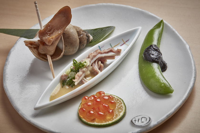 Babylonia japonica, yellowtail stomach with vinegar miso sauce and scallion topping, salmon roe and sugar snap pea with black sesame paste at Yamashita Restaurant in Kanazawa, Japan. — Picture by Andy Haslam/The New York Times