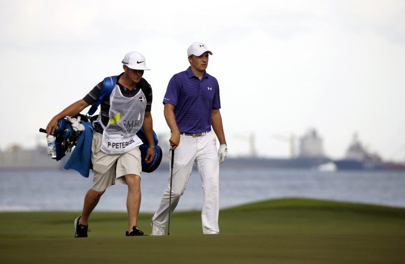 Jordan Spieth of the US walks down the sixth green with caddy of Paul Peterson of the US (not pictured) during the third round of the SMBC Singapore Open at Sentosau00e2u20acu2122s Serapong golf course in Singapore January 30, 2016. Reuters pic