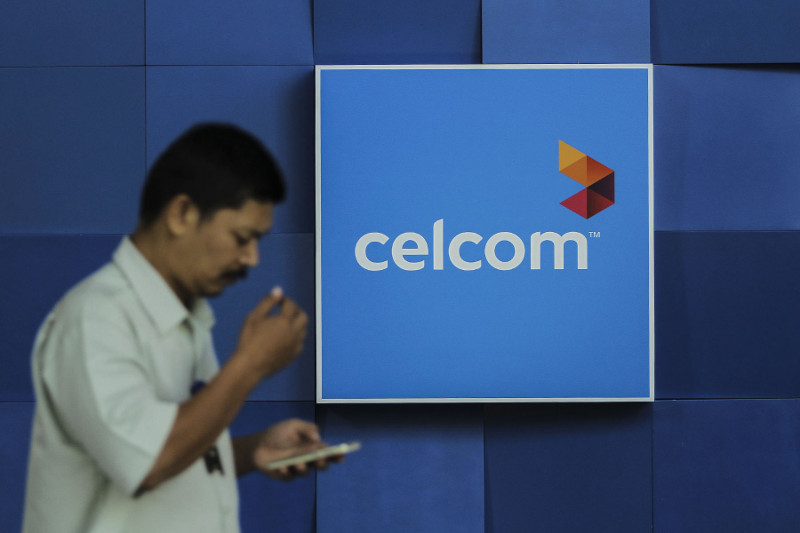 A man walks past a Celcom store in Kuala Lumpur, January 7, 2016. u00e2u20acu201d Picture by Yusof Mat Isa