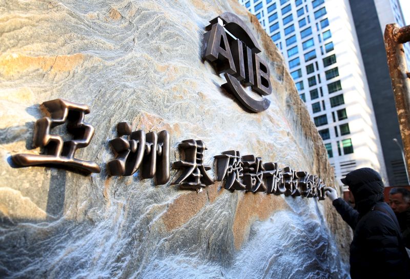A worker installs a sign of Asian Infrastructure Investment Bank at its headquarters ahead of its opening ceremony in Beijing, China, January 12, 2016. u00e2u20acu201d Reuters pic