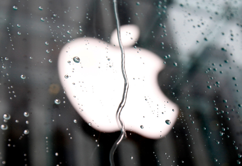 The Apple Inc logo is seen through raindrops on a window outside of its flagship store in New York, January 18, 2011. u00e2u20acu201d Reuters pic