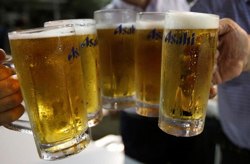 Tokyo businessmen toast with mugs of Asahi Breweries' beer after their office hours at a beer garden at the rooftop of Nihonbashi-Mitsukoshi department store in Tokyo July 30, 2013. u00e2u20acu201d Reuters pic