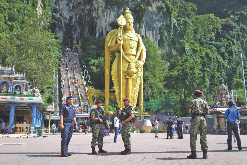 Military and police personnel work together to beef up security at Batu Caves. u00e2u20acu201d Picture by Ahmad Zamzahuri