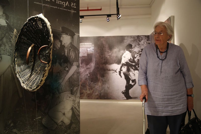 Jean Marshall, wife of David Marshall, viewing an old police riot shield during her tour of the Police Secret Bunker at Pearl’s Hill Terrace. — TODAY pic