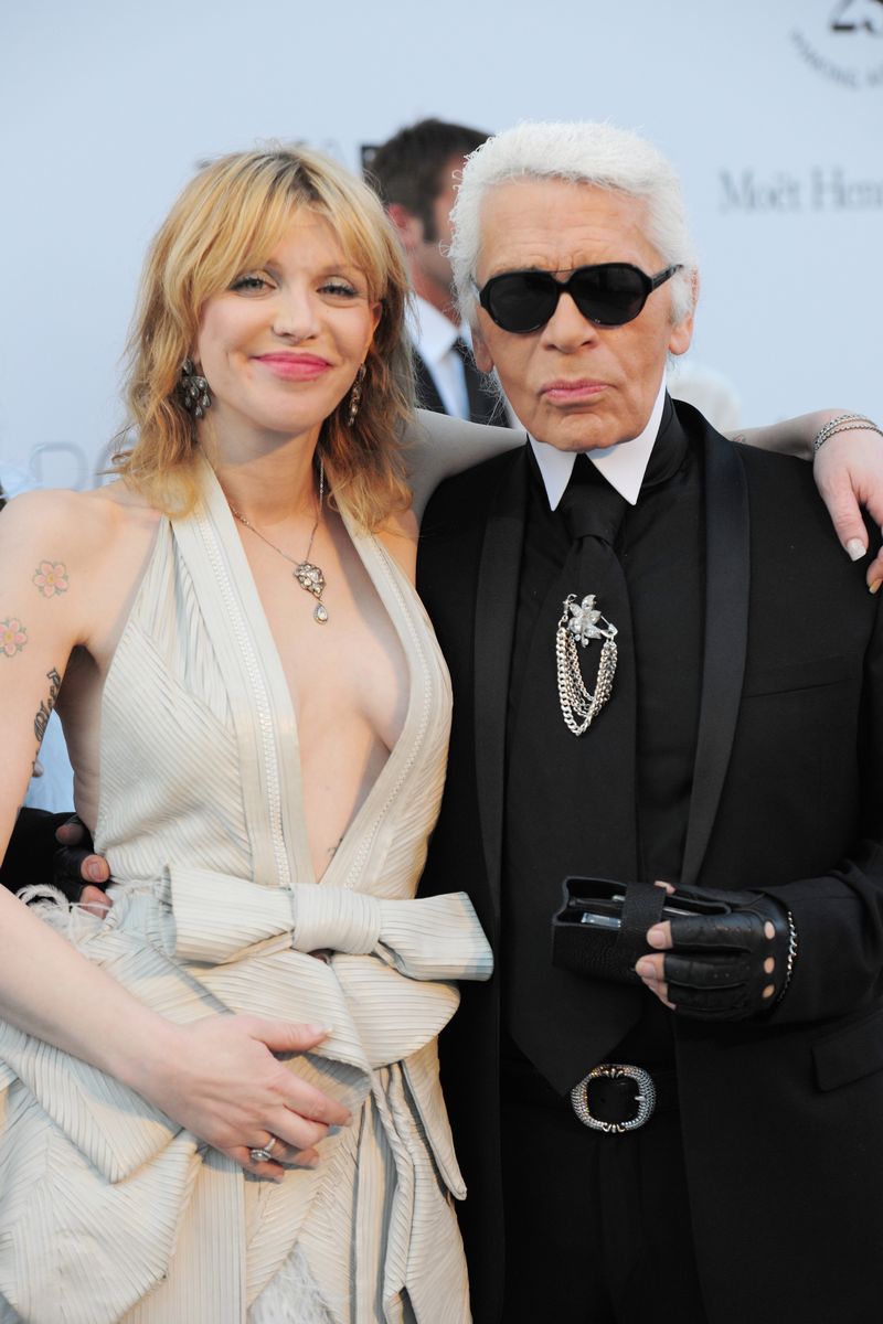 US musician Courtney Love and German fashion designer Karl Lagerfeld posing upon arrival to the 2011 amfAR's Cinema Against Aids benefit gala on the sidelines of the 64th Cannes Film Festival on May 19, 2011 in Antibes. — AFP pic