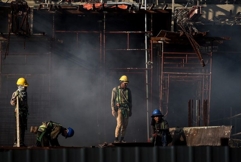 Men are seen working at a construction site in Kuala Lumpur, January 6, 2016. u00e2u20acu2022 AFP pic