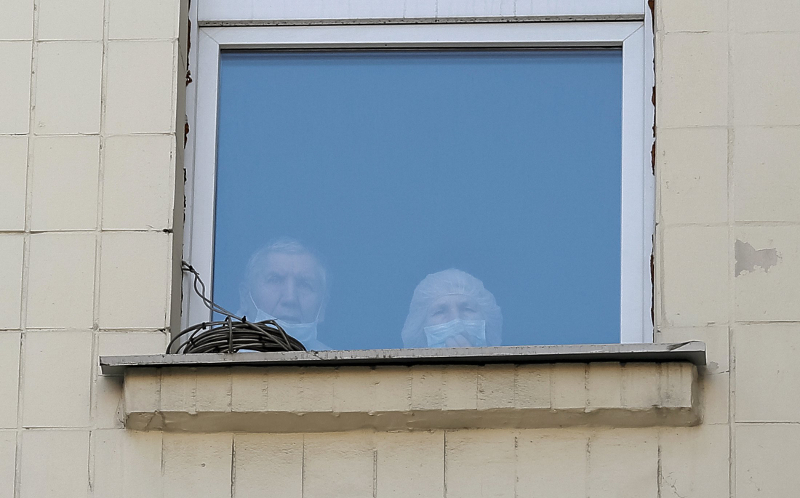 Two people wearing protective masks look out of a window at a hospital in central Kiev, Ukraine, January 15, 2016. u00e2u20acu201d Reuters pic