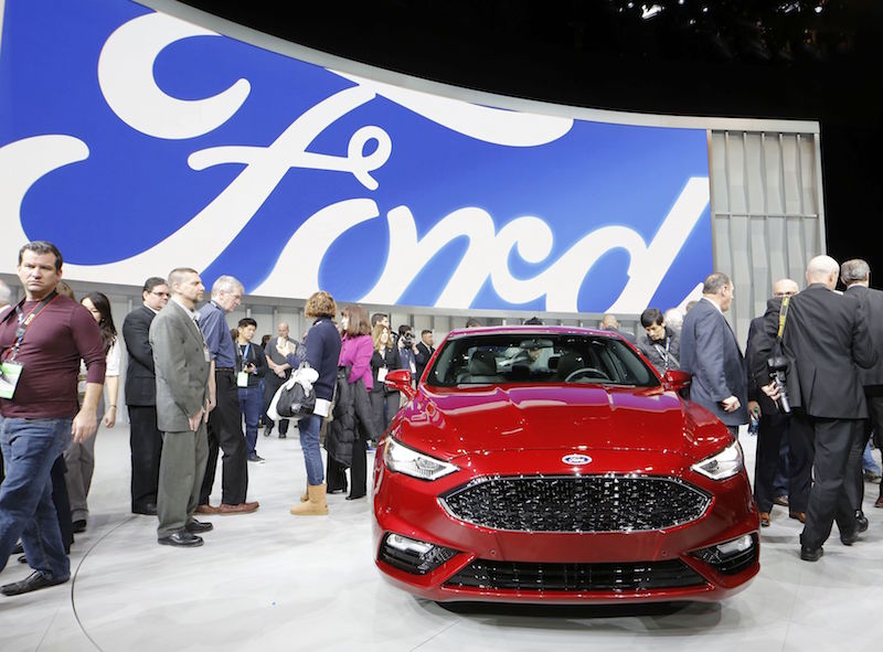 People crowd around a 2017 Ford Fusion being displayed at the North American International Auto Show in Detroit January 11, 2016. u00e2u20acu201d Reuters pic
