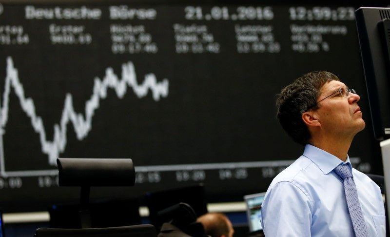 A trader works at his desk in front of the German share price index, DAX board, at the stock exchange in Frankfurt, Germany, January 26, 2016. u00e2u20acu2022 Reuters pic