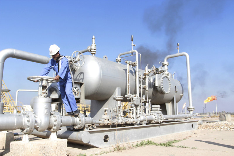 A worker checks the valve of an oil pipe at Nahr Bin Umar oil field, north of Basra, Iraq December 21, 2015. u00e2u20acu201d Reuters pic