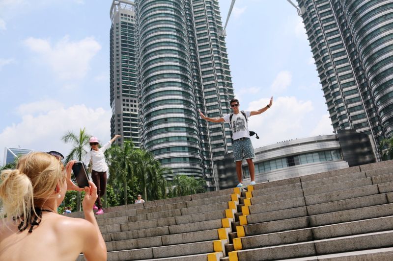 Tourists take pictures in front of the Petronas Twin Towers in Kuala Lumpur, January 19, 2015. u00e2u20acu2022 Bernama pic