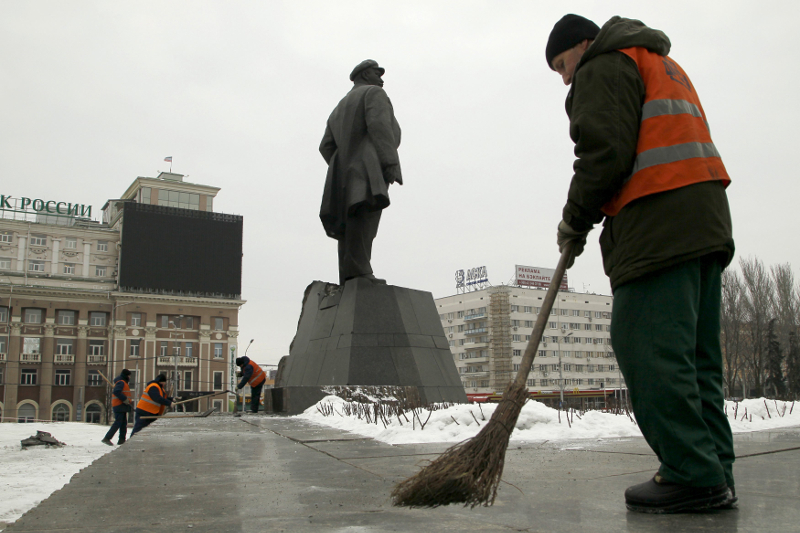 Sweepers clean a street near a monument of the Soviet state founder Vladimir Lenin, which was partly damaged in an explosion, in central Donetsk, Ukraine, January 27, 2016. u00e2u20acu201d Reuters pic