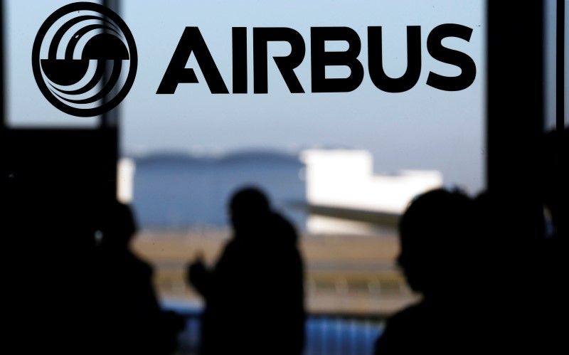 People silhouetted against a logo of the Airbus Group during the Airbus annual news conference in Colomiers, near Toulouse, January 13, 2015. REUTERS/Regis Duvignau