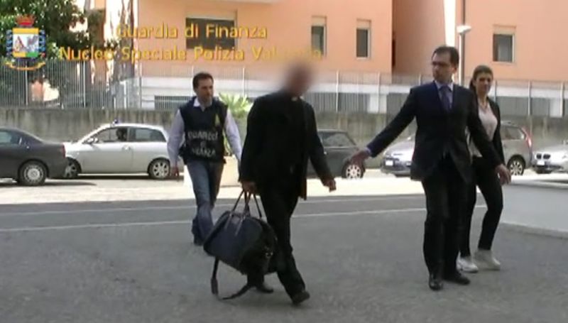 This handout picture taken from a video released by the Guardia di Finanzia Italian police on June 28, 2013 shows Nunzio Scarano (front left) escorted by policemen after being arrested the same day in Rome. u00e2u20acu201d AFP pic