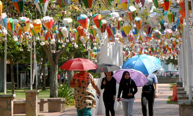  People brave the heat, as they take a leisurely stroll along a street in Penang,  January 13, 2016. u00e2u20acu2022 Bernama pic