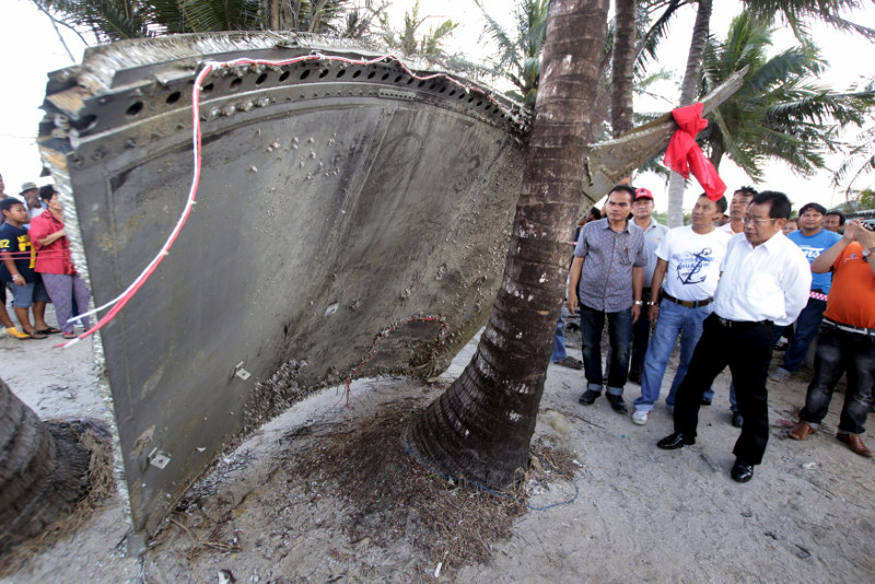 People stand next to a piece of suspected plane wreckage which has been found off the coast of southern Thailand in Nakhon Si Thammarat province, January 24, 2016. u00e2u20acu201d Reuters pic