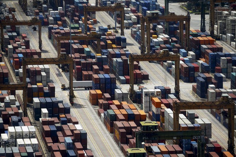 A truck passes containers at PSA's Tanjong Pagar container terminal in Singapore in this January 4, 2016 file photo. Singapore exports has been hit by weak sales to China. u00e2u20acu201d Reuters pic