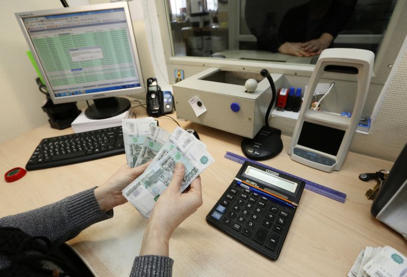 A cashier counts 1000-rouble banknotes while handing out salary to an employee at an office in Krasnoyarsk, Russia, January 24, 2016. u00e2u20acu2022 Reuters pic