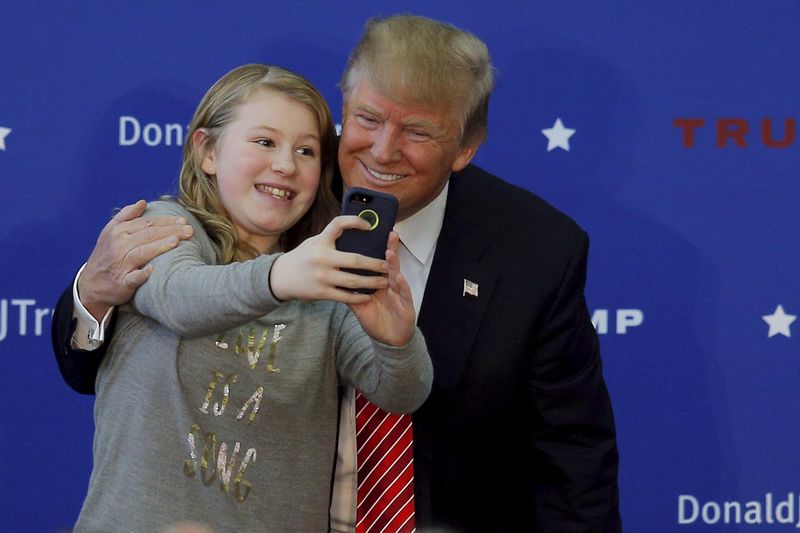 US Republican presidential candidate Donald Trump poses for a selfie with a young audience member onstage at a campaign rally in Portsmouth, New Hampshire January 16, 2016. u00e2u20acu201d Reuters pic