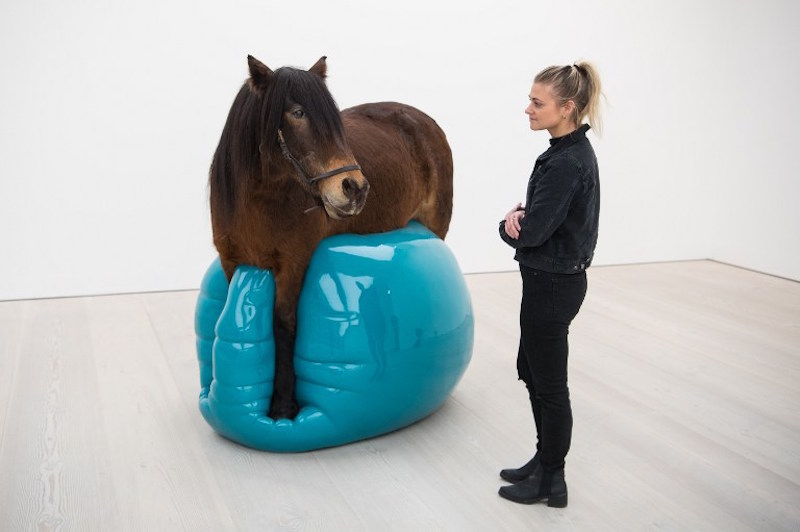 A gallery assistant poses for a photograph with an installation entitled u00e2u20acu02dcMoje Sabzu00e2u20acu2122 by Soheila Sokhanvari, displayed in the Saatchi Gallery in London January 12, 2016. u00e2u20acu201d AFP pic