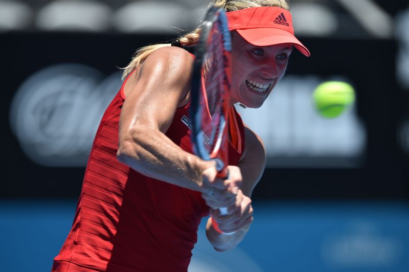 Angelique Kerber of Germany hits a return against Elina Svitolina of Ukraine, first round, Sydney International, January 11, 2016. AFP PHOTO / Peter PARKS 