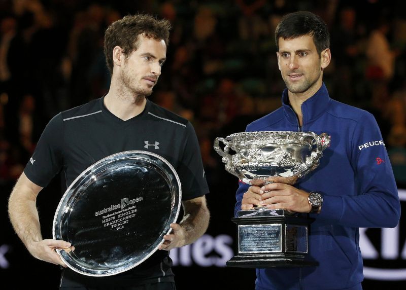 Serbiau00e2u20acu2122s Novak Djokovic (R) with menu00e2u20acu2122s singles trophy beside Britainu00e2u20acu2122s Andy Murray after winning their final at the Australian Open at Melbourne Park January 31, 2016. REUTERS/Tyrone Siu