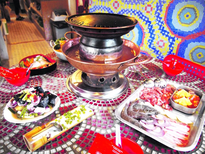 Black chicken soup, Thai Mama noodles and fish paste in bamboo are some of the interesting items on Tom Yum Kungfu’s Mookata menu.  — TODAY pic