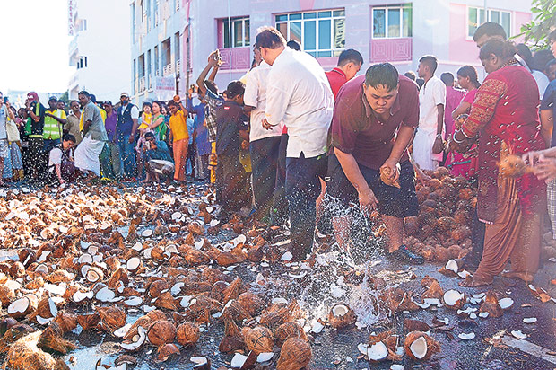 Devotees smashing coconuts as the Silver Chariot makes its way to the hill-top temple in Penang on Thaipusam, January 23, 2016. — Picture by K.E. Ooi