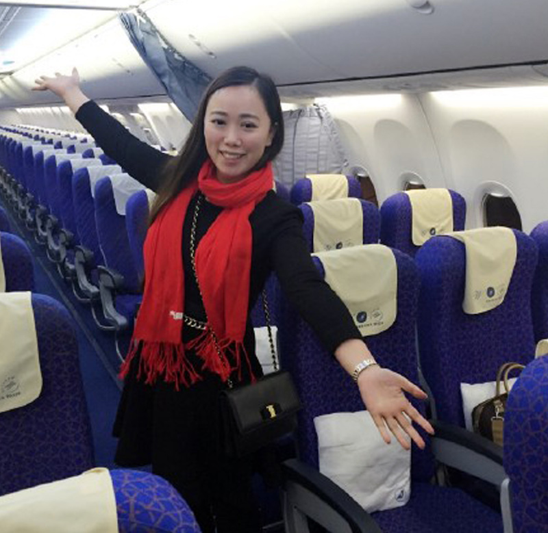 A Chinese woman surnamed Zhang poses for photos on an empty flight from Wuhan to Guangzhou. u00e2u20acu201d AFP pic