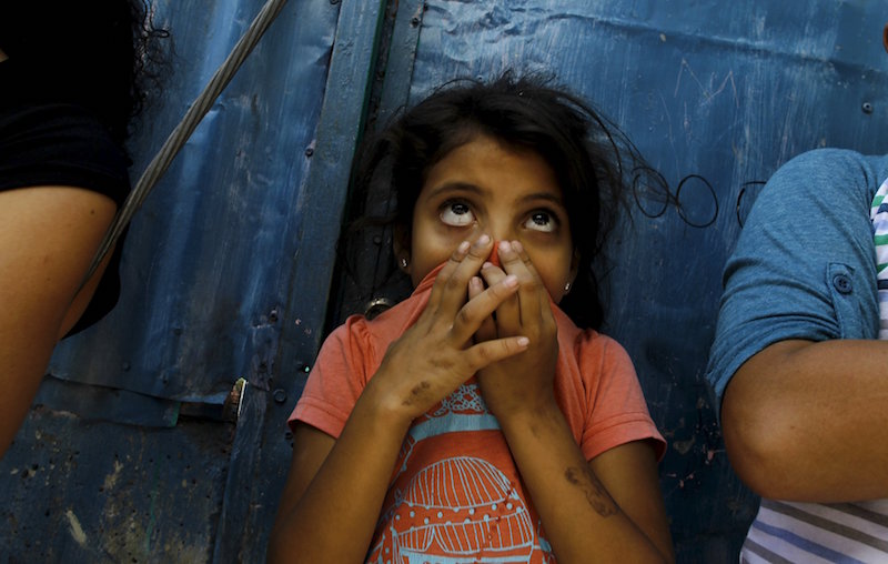 A child covers her nose as a health worker fumigates in La Carpio slum to help control the spread of the mosquito-borne Zika virus in San Jose, Costa Rica February 2, 2016. u00e2u20acu201d Reuters pic