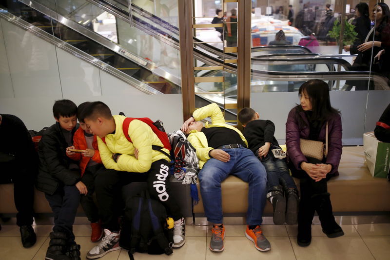 Chinese tourists rest as they shop at a Lotte department store in central Seoul February 2, 2016. — Reuters pic
