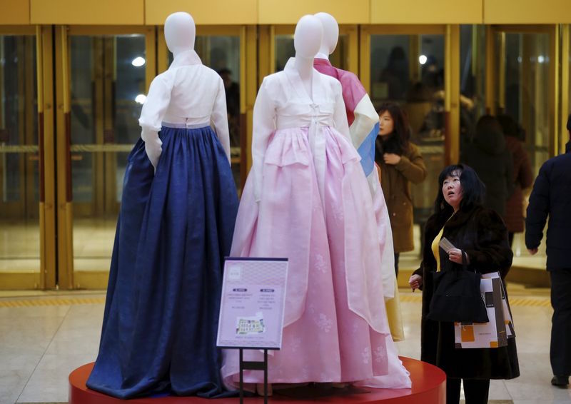 A Chinese tourist looks at Korean traditional dress Hanbok on display at a Lotte department store in central Seoul February 2, 2016. u00e2u20acu201d Reuters pic