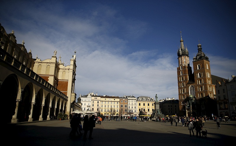 People walk in front of St. Maryu00e2u20acu2122s Basilica (right) at the Old Town Market Square in Krakow, Poland February 1, 2016. u00e2u20acu201d Reuters pic