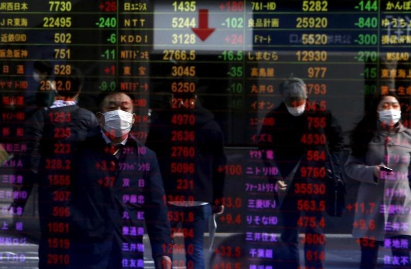 Pedestrians are reflected in an electronic board displaying various stock prices at a brokerage in Tokyo, Japan on February 4, 2016. u00e2u20acu201d Reuters pic
