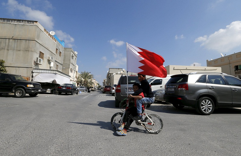 Youths are seen cycling with a Bahraini flag in the village of Diraz west of Manama, Bahrain on February 12, 2016. u00e2u20acu201d Reuters pic