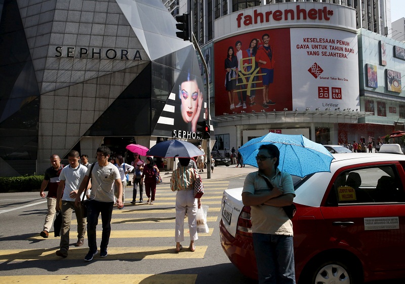 A taxi driver waits for customers in the main shopping district of Kuala Lumpur on February 18, 2016. u00e2u20acu201d Reuters pic
