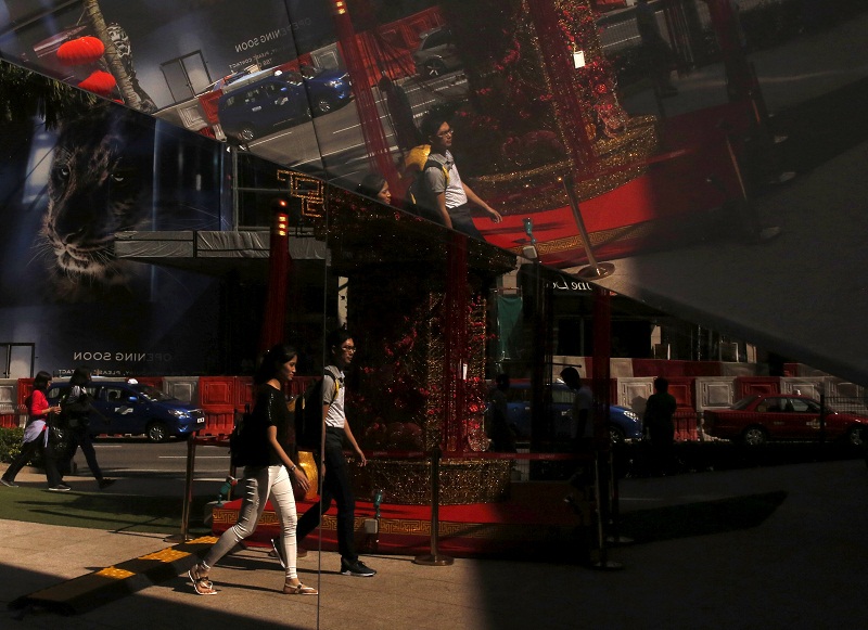 Shoppers are reflected in a window in the main shopping district of Kuala Lumpur on February 18, 2016. u00e2u20acu201d Reuters pic