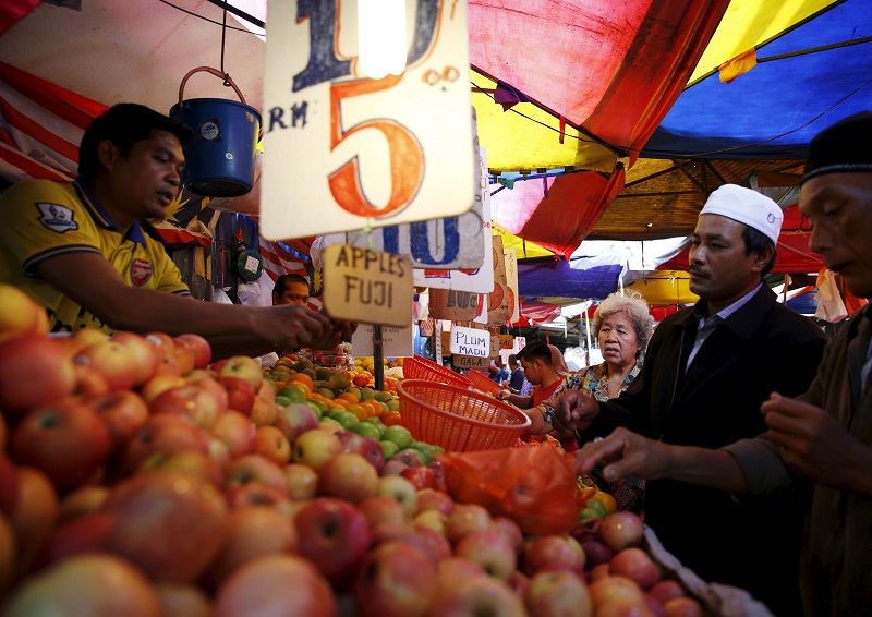 People buy fruits at a market in Kuala Lumpur on February 18, 2016. u00e2u20acu201d Reuters pic