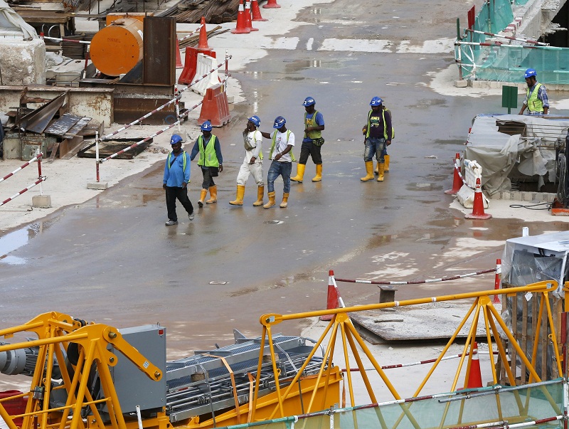 Workers walk at a building site in Kuala Lumpur on February 18, 2016. u00e2u20acu201d Reuters pic