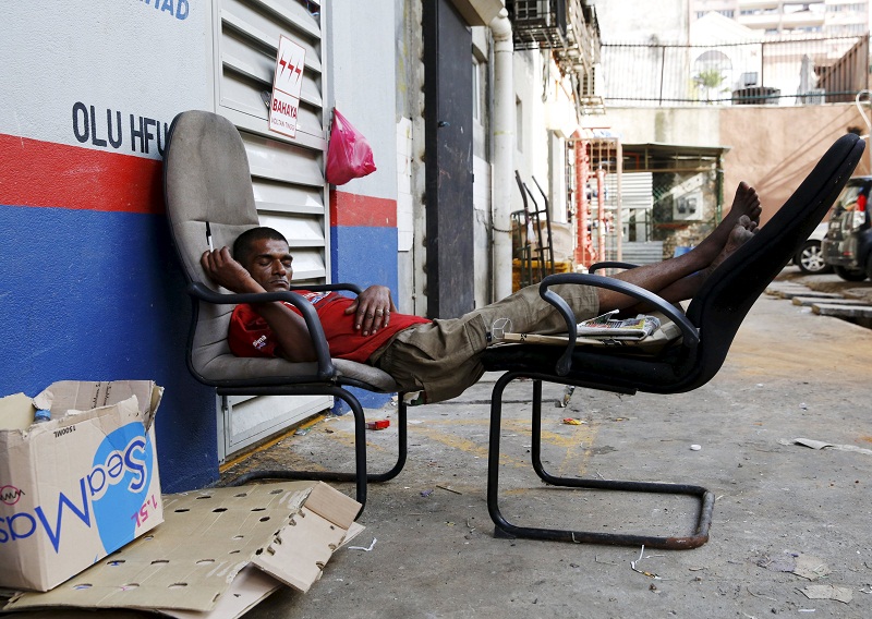 A night worker sleeps at the end of his shift at a market in Kuala Lumpur February 18, 2016. u00e2u20acu201d Reuters pic