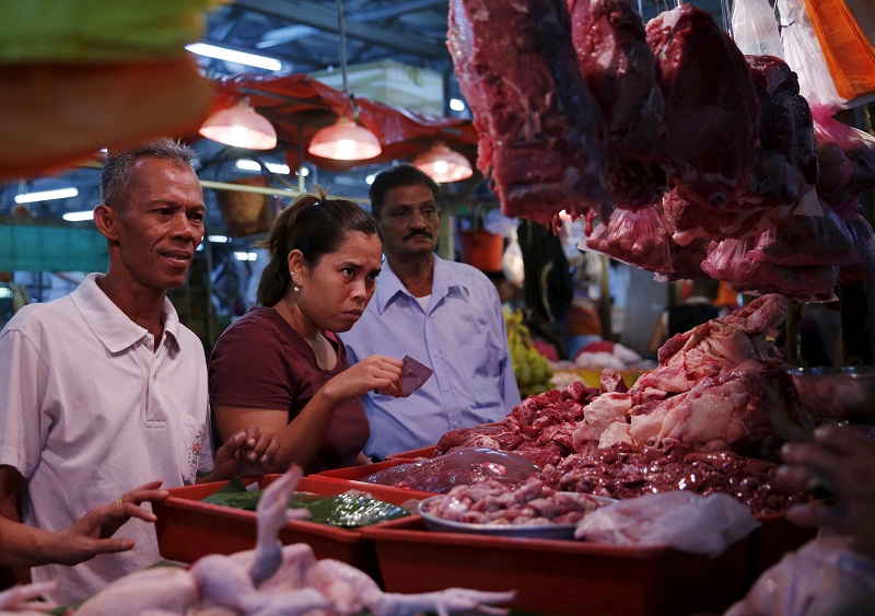 People buy meat at a wet market in Kuala Lumpur on February 18, 2016. u00e2u20acu201d Reuters pic