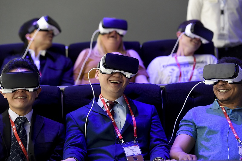 Visitors smile as they test the new 'Oculus VR' virtual device at the Samsung stand during the Mobile World Congress in Barcelona. u00e2u20acu201d AFP pic