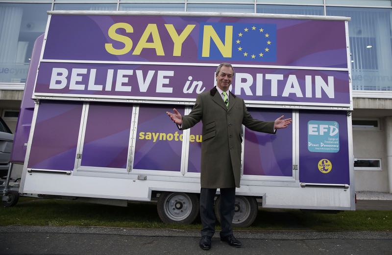 Britainu00e2u20acu2122s UKIP party leader Nigel Farage poses in front of a poster as he arrives at the party's spring conference, in Llandudno, Britain, February 27, 2016. u00e2u20acu201d Reuters pic